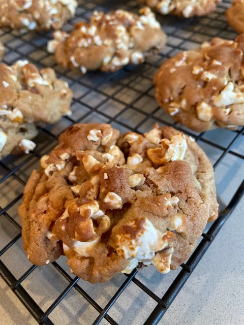 Close-up of freshly baked cookies, cooling on a wire rack.
